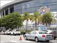  ?? LYNNE SLADKY — THE ASSOCIATED PRESS ?? Vehicles pass by the home run sculpture as they wait in line outside of Marlins Park at a COVID-19testing site during the coronaviru­s pandemic, Monday, in Miami.