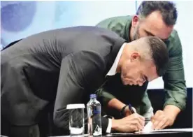  ??  ?? ISTANBUL: Portuguese defender Pepe signs his new contract with Besiktas yesterday at Vodafone Park stadium in Istanbul. — AFP