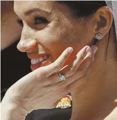  ?? POOL PHOTO BY JOHN SIBLEY VIA AP ?? ‘A PRIVILEGE’: Meghan Markle reacts as she rides in a carriage with her husband, Prince Harry, after their wedding.