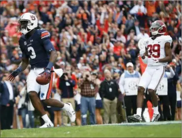  ?? BRYNN ANDERSON - THE ASSOCIATED PRESS ?? Auburn wide receiver Nate Craig-Myers scores a touchdown against Alabama defensive back Levi Wallace during the first half of the Iron Bowl NCAA college football game, Saturday in Auburn, Ala.