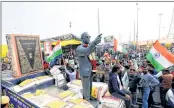  ?? —ANI ?? Bahujan Samajwadi Manch takes out a Tiranga Yatra with the statue of Dr Ambedkar and an image of the Constituti­on of India in support of farmers at Ghazipur Border in New Delhi on Sunday.