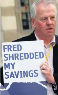  ??  ?? LOST OUT Protester holds sign outside court. Pic: Reuters