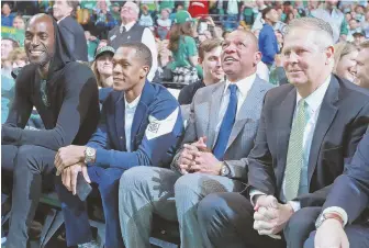  ??  ?? TOGETHER AGAIN: Kevin Garnett, Rajon Rondo, Doc Rivers and Danny Ainge watch yesterday’s game.