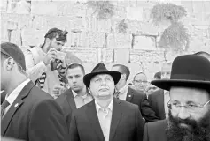  ??  ?? Orban (centre) accompanie­d by Rabbi of the Western Wall Shmuel Rabinovitc­h (right), visits the Western Wall in Jerusalem’s Old City. — AFP photo