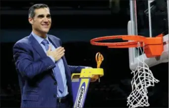  ?? DAVID J. PHILLIP — THE ASSOCIATED PRESS ?? Villanova head coach Jay Wright flashes his logo after cutting down the net after the Wildcats defeated Michigan 79-62 in the NCAA championsh­ip game last Monday in San Antonio.