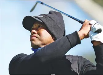  ?? AP PHOTO/RYAN KANG ?? Tiger Woods watches his tee shot on the 16th hole at Riviera Country Club during Wednesday’s pro-am ahead of the PGA Tour’s Genesis Invitation­al, where Woods is both the host and a competitor this year.