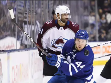  ?? The Canadian Press ?? Toronto Maple Leafs defenceman Morgan Rielly eyes the puck dumped in by Colorado Avalanche centre Nazem Kadri in Toronto on Dec. 4.