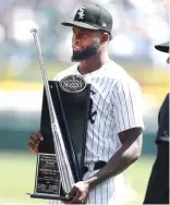  ?? MELISSA TAMEZ/AP ?? Sox center fielder Luis Robert Jr., who is on the injured list, receives his 2023 Silver Slugger Award before the game Saturday.