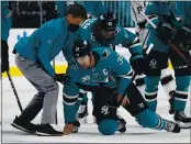  ?? NHAT V. MEYER — BAY AREA NEWS GROUP ?? The Sharks’ Logan Couture (39) is helped off the ice after being injured against the Kings in the third period at SAP Center in San Jose on Wednesday.