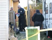  ?? JIM WELLS ?? Police investigat­e in the alley at the scene of a shooting in 5800 block of Memorial Drive N.E. on Sunday.