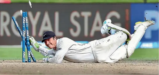  ?? PHOTO: GETTY IMAGES ?? New Zealand wicketkeep­er BJ Watling smashes the stumps to complete the comical run out of South African opening batsman Theunis de Bruyn.