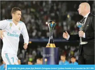  ??  ?? ABU DHABI: File photo shows Real Madrid’s Portuguese forward Cristiano Ronaldo (L) is awarded the 2017 FIFA Club World Cup Silver Ball by FIFA President Gianni Infantino. —AFP