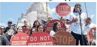  ?? MOLLY RILEY/AP 2015 ?? Councilman Wendsler Nosie speaks with activists from the Apache Tribe in a rally to save sacred land known as Oak Flat near Superior, Arizona.