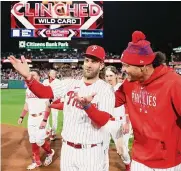  ?? Tim Nwachukwu/getty Images ?? Bryce Harper and Taijuan Walker, right, hope to celebrate more than earning a playoff spot.