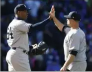  ?? NAM Y. HUH — ASSOCIATED PRESS ?? Yankees closer Aroldis Chapman, left, celebrates with Brett Gardner after the Yankees defeated the Cubs 3-2 in an interleagu­e baseball game Friday in Chicago.