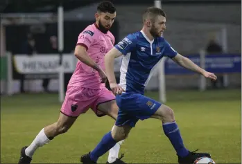  ??  ?? Anthony McAlavey of Waterford has Shane Dunne breathing down his neck.