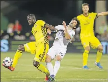  ?? [JOSHUA A. BICKEL/DISPATCH] ?? Crew defender Jonathan Mensah clears the ball past Nicolas Lodeiro of the Sounders.