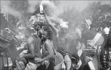  ?? CRAIG RUTTLE/AP PHOTO ?? Powder flies in the air over revelers at the West Indian American Day Parade in the Brooklyn borough of New York, Monday. New York’s Caribbean community has held annual carnival celebratio­ns since the 1920s, first in Harlem and then in Brooklyn, where festivitie­s happen on Labor Day.