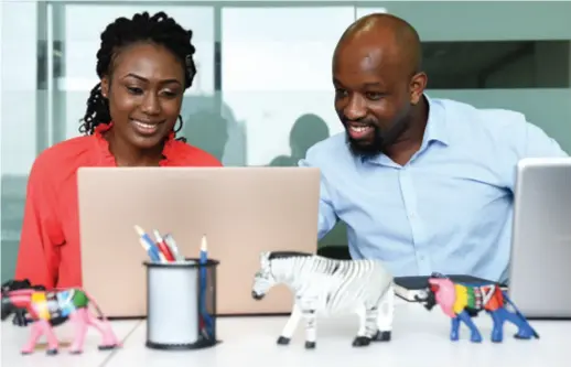  ??  ?? Kenyan young entreprene­ur Edwin Mwenda (right) and his partner Nelly Njoroge have a discussion on their entreprene­urial project at a business incubator in Beijing on August 17, 2018