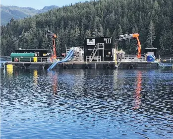  ??  ?? Marine Harvest Canada is using a “hydrolicer” barge to treat farmed Atlantic salmon for sea lice.
