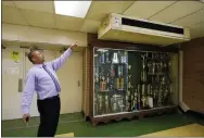  ?? ROGELIO V. SOLIS - THE ASSOCIATED PRESS ?? Jim Hill High School Principal Bobby Brown points out one of the outdated air-conditioni­ng units installed throughout the Jackson, Miss., school, on Jan. 12.