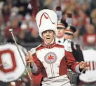  ?? JOSHUA A. BICKEL/COLUMBUS DISPATCH ?? With his baton suspended in midair, Ohio State drum major Austin Bowman performs a series of twirls and catches at halftime on Sept. 25.