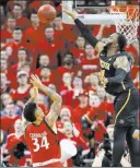  ?? Gary Landers ?? The Associated Press Wichita State center Shaquille Morris blocks a shot by Cincinnati guard Jarron Cumberland in the second half of the No. 19 Shockers’ 76-72 win Sunday.