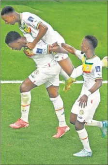  ?? AFP ?? Senegal's Bamba Dieng (L) celebrates after scoring against Qatar during their 3-1 win at the Al-Thumama Stadium in Doha on Friday.