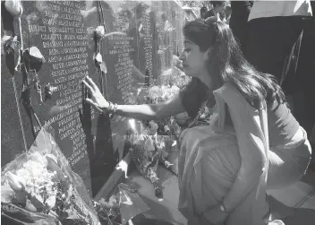  ?? JACK BOLAND / POSTMEDIA NEWS FILES ?? Jyoti Rana runs her fingers across her aunt’s name — Shyla “Juju” Aurora — on the polished granite wall of the Air India memorial in Toronto.