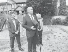  ??  ?? B.C. NDP Leader John Horgan, centre, with MLAs Rob Fleming and Carole James on Tuesday. Horgan says an NDP government would fix loopholes that favour bad landlords.