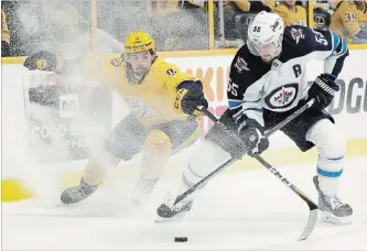  ?? ASSOCIATED PRESS FILE PHOTO ?? Nashville’s Filip Forsberg, left, battles Winnipeg’s Mark Scheifele in playoff game last month.