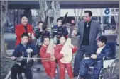  ?? PROVIDED TO CHINA DAILY ?? Wang Kuan and his wife watch their adopted children play instrument­s.