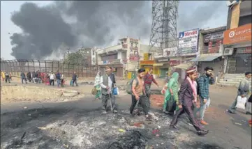  ?? PTI PHOTO ?? A bridegroom among a group of people walking past the Bhagirathi Vihar area in riot-hit north-east Delhi on Wednesday.