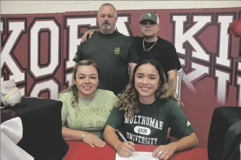  ?? PHOTO By rOBErT BrEWEr/YUMA SUN ?? KOFA SENIOR CASSANDRA SANDOVAL signs her National Letter of Intent to play soccer for Multnomah University, an NAIA college located in Oregon. She is joined by her mother Rosemarie, father Richard and brother Elliot.