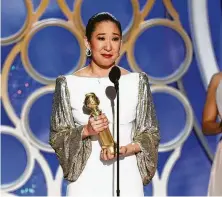  ?? Paul Drinkwater / Associated Press ?? Sandra Oh looks lovely in a white Atelier Versace gown with Swarovski crystals.