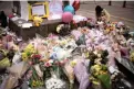  ?? PICTURE: AP ?? IN MEMORY: A woman places flowers after the attack at a concert that left 22 people dead in Manchester.