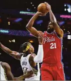  ?? Chris Szagola / Associated Press ?? The 76ers’ Joel Embiid shoots the ball with the Pacers’ Buddy Hield defending during the second half on Saturday.