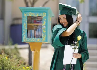  ??  ?? Calixta Guerrero, 17, shifts her tassel after collecting her diploma during the Los Alamos High School commenceme­nt ceremony. ‘We’ve worked so hard to get to this point, 12 years of school. … I think through all of these hard times, COVID-19 and everything, it’s definitely good to have some normal,’ she said.