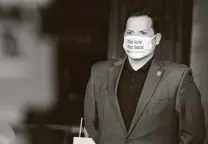  ?? Kin Man Hui / Staff file photo ?? Bexar County Precinct 2 Commission­er Justin Rodriguez wears a mask while encouragin­g people to vote in this Oct. 8 photo.