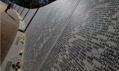  ?? Photograph: AFP/Getty Images ?? A woman stands in front of the Shoah Name Wall Memorial in Vienna, containing names of 64,440 Austrian Jews murdered during the Nazi era.