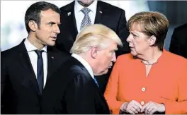  ?? ARMANDO BABANI/EPA ?? France’s Emmanuel Macron talks with Germany’s Angela Merkel in Brussels as President Trump walks by. At one point last week, Macron walked past Trump to greet Merkel.