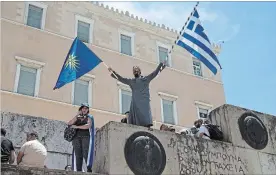  ?? PETROS GIANNAKOUR­IS THE ASSOCIATED PRESS ?? A protest takes place outside the parliament in Athens on Friday against the agreement between Greece and Macedonia over dispute of the former Yugoslav republic’s name.