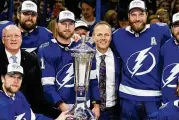  ?? ?? Tampa Bay Lightning center Steven Stamkos (91), head coach Jon Cooper, and defenseman Victor Hedman (77) pose with the Prince of Wales Trophy after the team