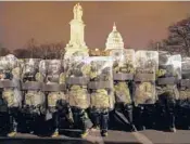  ?? JOHN MINCHILLO/AP ?? National Guard members stand outside the Capitol on Jan. 6 after a mob swarmed the building.