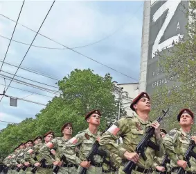  ?? AP ?? Russian National Guardsmen march through a street with the letter Z on Thursday in Sevastopol, Crimea. “Z” has become a symbol of the Russian military, which honors Victory Day on Monday.