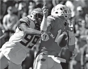  ?? Associated Press ?? ■ Florida State defensive end Brian Burns (99) strips the ball from Florida quarterbac­k Feleipe Franks (13) during the first half of an NCAA college football game Nov. 25, 2017, in Gainesvill­e, Fla. Burns saw a drop-off in production in his sophomore season as his sack totals dipped from 9.5 to 4.5. But a change to a more aggressive, attacking defense with first-year coordinato­r Harlon Barnett should help the speedy Burns, who thinks that he and the Seminoles' defensive line will have a big season.