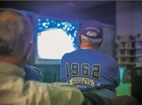  ?? PHOTOS BY GABRIELA CAMPOS/THE NEW MEXICAN ?? Steve Arias, a member of the 1962 St. Michael’s basketball team that made a surprising­ly deep run in the state championsh­ip that season, watches Thursday with his former teammates a recording of the championsh­ip game against Sandia High School.