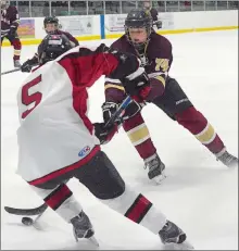  ?? DANA JENSEN/THE DAY ?? Kyle Jacobson (74) of the Eastern Connecticu­t Eagles makes a move around Colin Larkin (5) of the Redhawks during the Eagles’ 7-1 win on Wednesday at the Rose Garden Arena in Norwich.