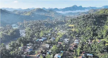  ??  ?? An aerial view of the village of Mandena and the lush surroundin­g mountains in Madagascar’s northeaste­rn Sava region. With vanilla prices reaching hundreds of dollars a pound, the region is in the midst of an economic boom.