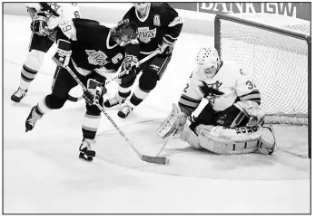  ?? AP FILE PHOTO (1994) ?? Wayne Gretzky of the Los Angeles Kings scores his 800th career goal March 20, 1994, in San Jose against the Sharks. “The Great One” ended his career with 894 goals, the NHL’S highest total. More impressive, though, he ended his career with 2,857 points — a mark that many believe will never be bested.